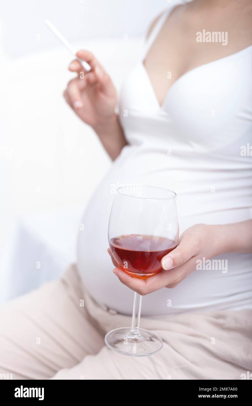 Ungesunde Essgewohnheiten, schwangere Frauen schwangere Frauen mit Alkohol und Tabak Stockfoto