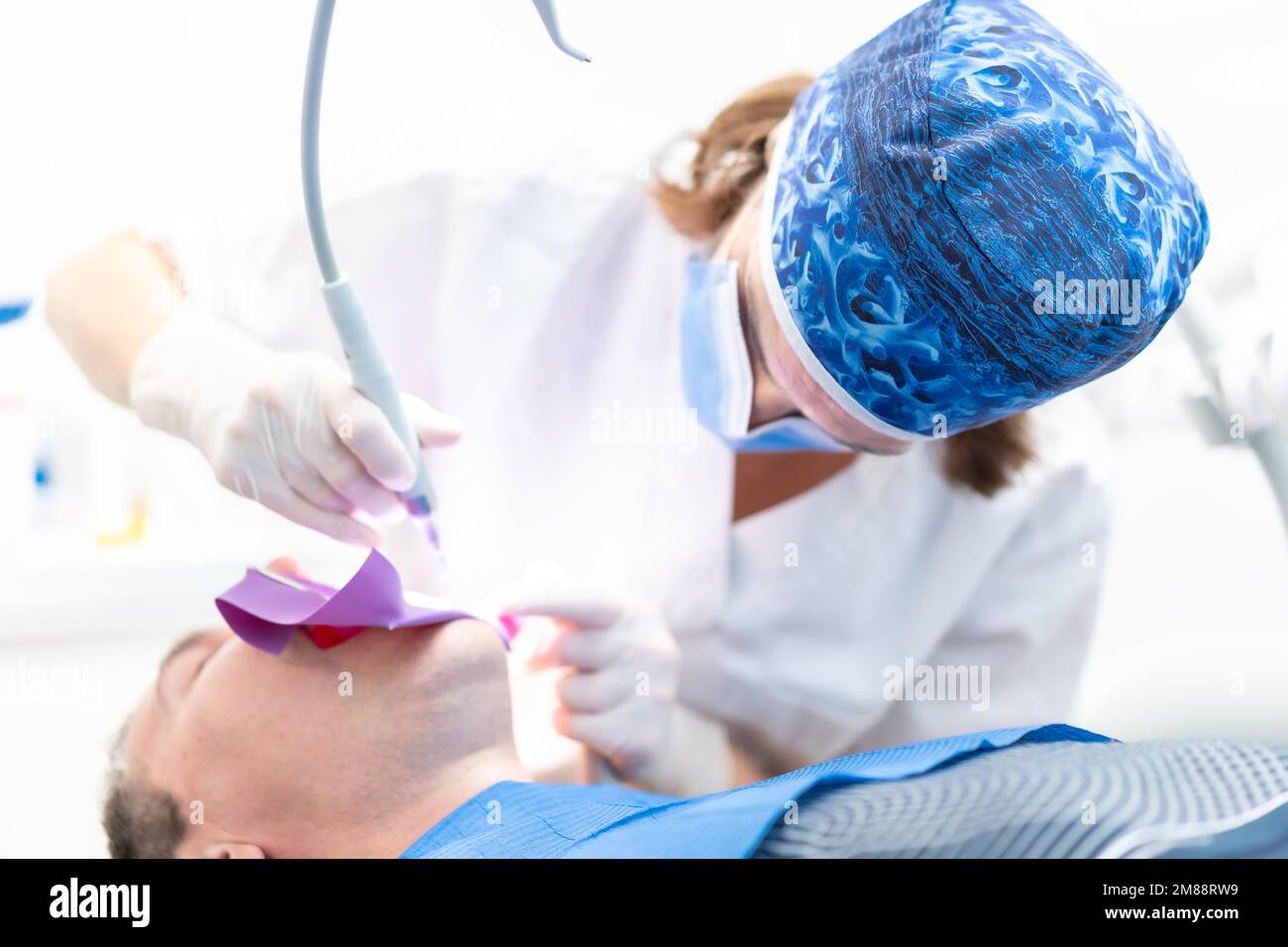 Zahnklinik, ein Arzt, der einem Patienten bei Volloperation einen Wurzelkanal vorführt Stockfoto