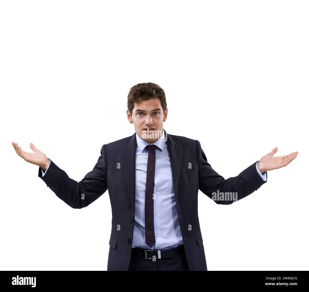 Ich fühle mich missverstanden. Ein Geschäftsmann, der vor weißem Hintergrund zuckt. Stockfoto
