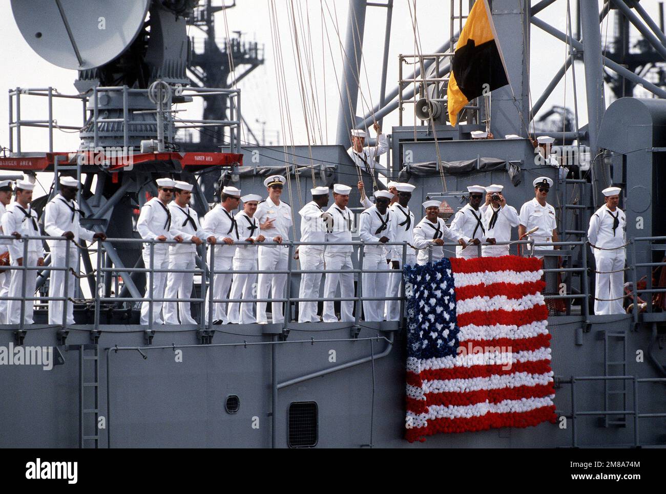Die Besatzungsmitglieder richten sich auf die Schienen, während die geführte Raketenfregatte USS STARK (FFG-31) in ihren Heimathafen zurückkehrt. Die STARK hat soeben Seeversuche abgeschlossen, die auf einen Aufenthalt in der Ingalls-Schiffbauanlage in Pascagoula, Miss, folgten, für Reparaturen an den umfangreichen Schäden, die durch zwei irakische Exocet-Abwehrraketen verursacht wurden, die das Schiff während seiner Patrouille im Persischen Golf im Mai 1987 getroffen haben. 37 Crewmitglieder kamen bei der Explosion und den Bränden ums Leben. Basis: Marinestützpunkt, Mayport Bundesstaat: Florida (FL) Land: Vereinigte Staaten von Amerika (USA) Stockfoto