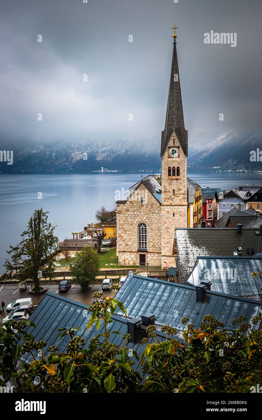 Hallstatt, Österreich - der weltberühmte Hallstatt, die zum UNESCO-Weltkulturerbe gehörende Stadt am See mit der Lutherischen Kirche Hallstatt an einem kalten nebligen Tag mit Schneefall Stockfoto