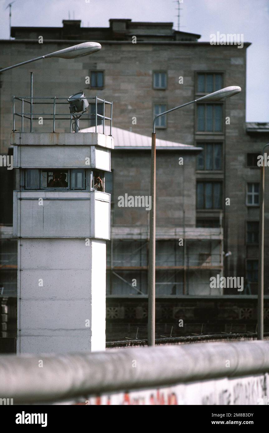 Grenzschutzbeamte halten Wache von einem Turm auf der ostdeutschen Seite der Berliner Mauer. Basis: Berlin Land: Deutschland / Deutschland (DEU) Stockfoto