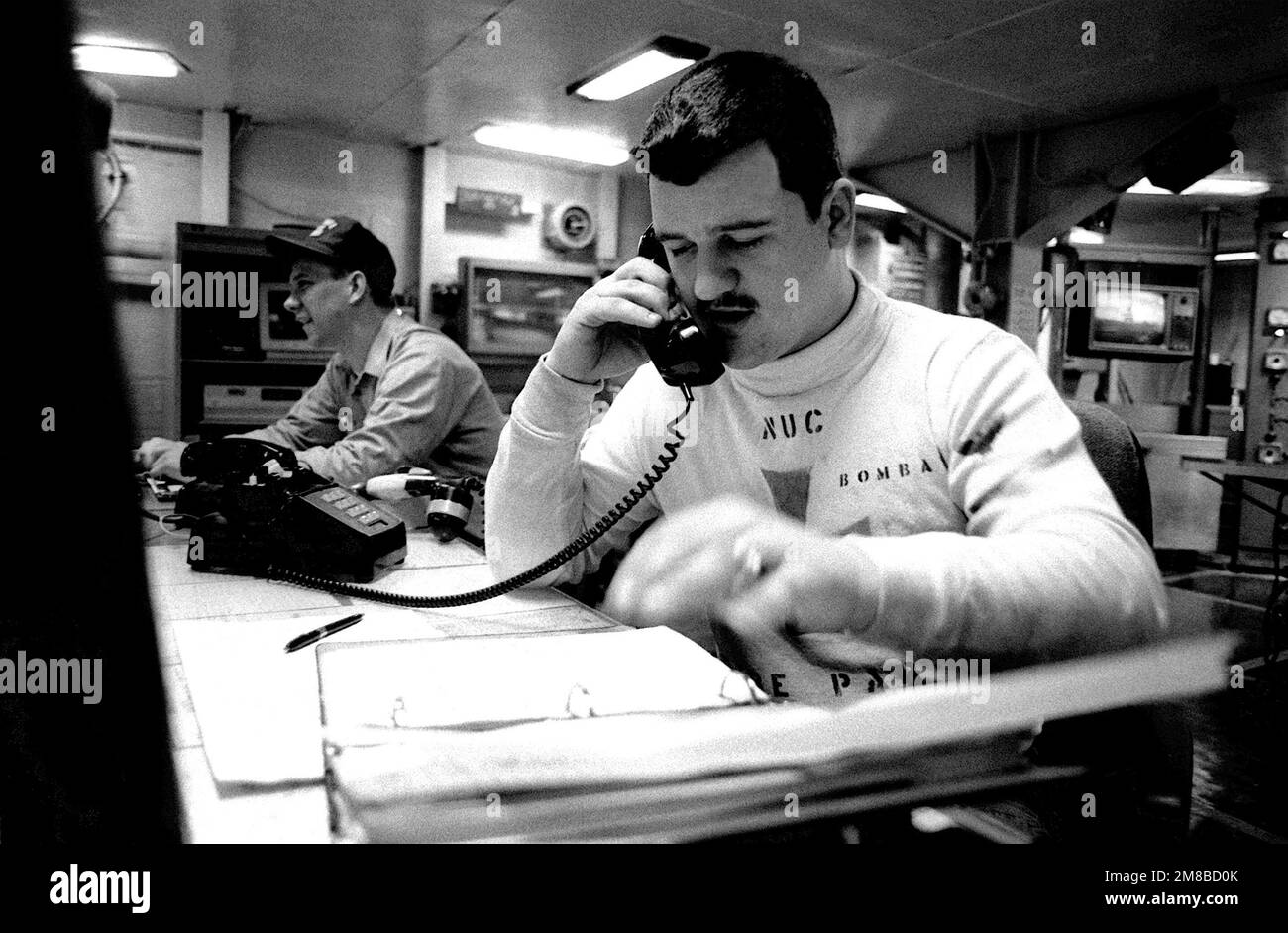 Ein Besatzungsmitglied kommuniziert während der Übung SOLID SHIELD '89 mit schallbetriebenen Telefonen an Bord des nuklearbetriebenen Flugzeugträgers USS DWIGHT D. EISENHOWER (CVN-69). Betroffene Operation/Serie: SOLIDES SCHILD '89 Land: Unbekannt Stockfoto