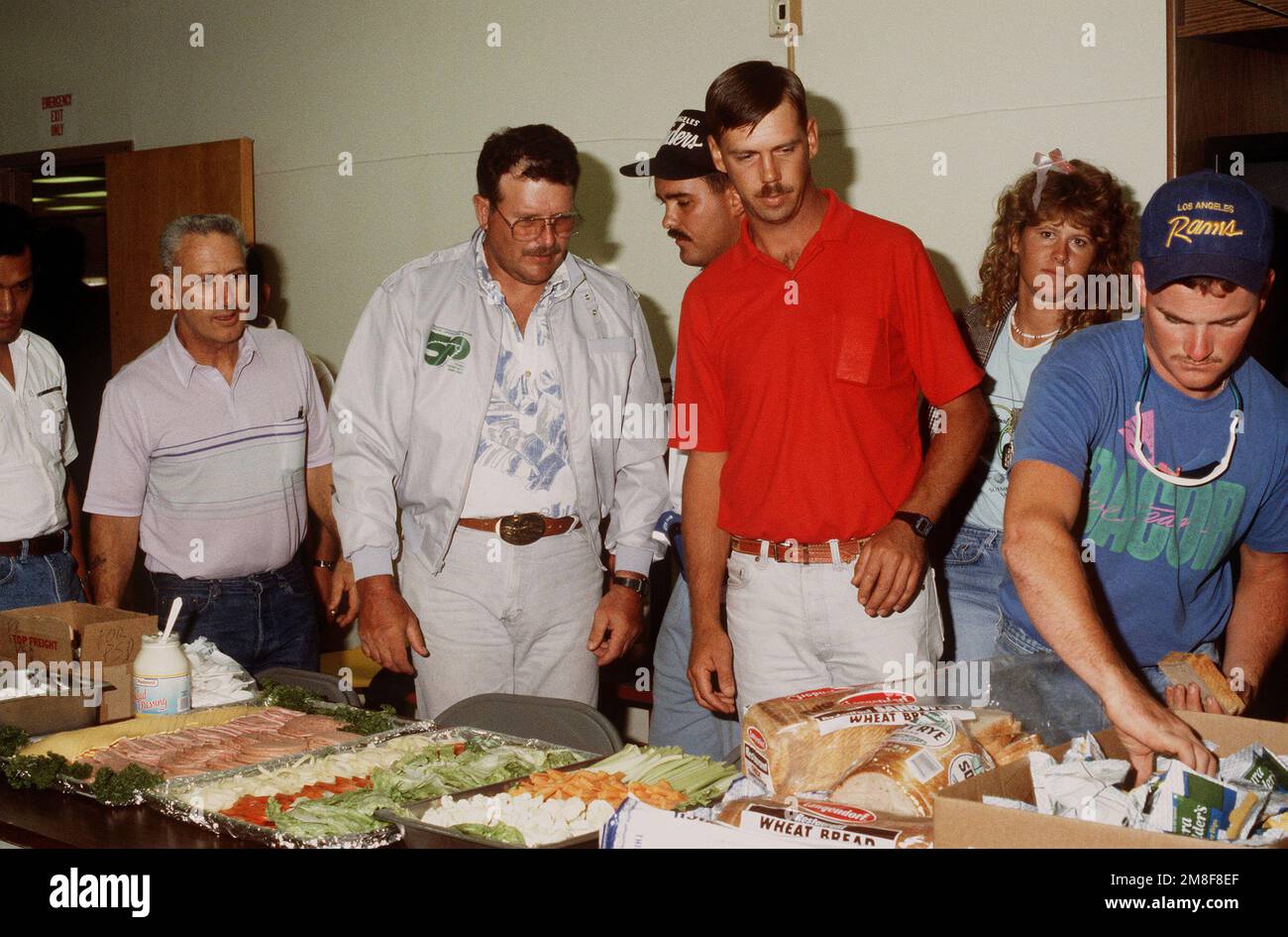 Navy Reservists stehen Schlange, um Sandwiches zu machen, während sie warten, bis ihre Bearbeitung durch das Naval Reserve Readiness Command 20 (REDCOM-20) Personalunterstützungsteam abgeschlossen ist. Die Reservisten sind gerade aus dem Dienst im Persischen Golf nach der Operation Desert Storm zurückgekehrt. Betreff Operation/Serie: WÜSTENSTURMBASIS: San Francisco Bundesstaat: Kalifornien (CA) Land: Vereinigte Staaten von Amerika (USA) Stockfoto