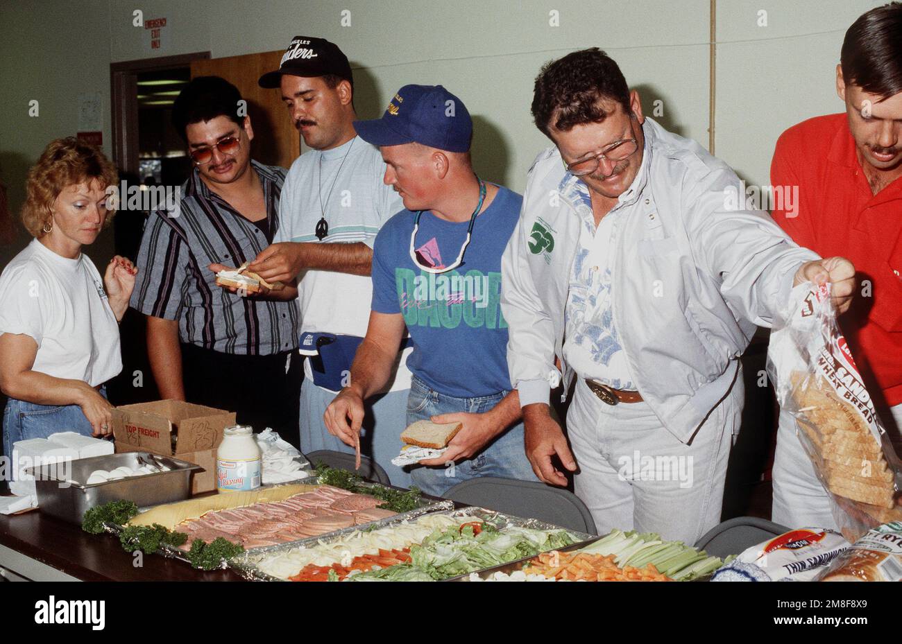 Navy Reservists stehen Schlange, um Sandwiches zu machen, während sie warten, bis ihre Bearbeitung durch das Naval Reserve Readiness Command 20 (REDCOM-20) Personalunterstützungsteam abgeschlossen ist. Die Reservisten sind gerade aus dem Dienst im Persischen Golf nach der Operation Desert Storm zurückgekehrt. Betreff Operation/Serie: WÜSTENSTURMBASIS: San Francisco Bundesstaat: Kalifornien (CA) Land: Vereinigte Staaten von Amerika (USA) Stockfoto