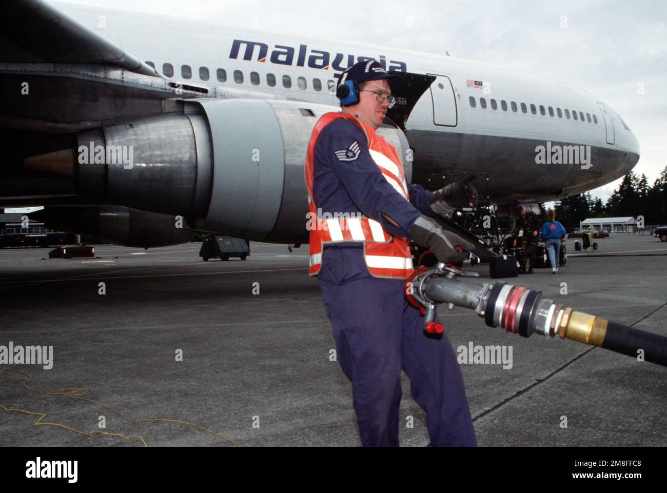 SSGT James L. Nelson, ein Crewchef von McChords 62. Generation Flugzeugstaffel, trägt während der Operation Fiery Vigil einen Treibstoffschlauch beim Betanken des malaysischen Flugzeugs. Zivile Flugzeuge werden verwendet, um Hunderte von US-Bürgern zu evakuieren Air Force- und Navy-Personal, zivile Angestellte und ihre Angehörigen aus den Philippinen nach dem Sturz der Asche durch den Ausbruch des Mount Pinatubo stürzten Gebäude und unterbrachen Operationen auf Militärstützpunkten. Einsatzgebiet/Serie: FIERY WIGIL Base: Luftwaffenstützpunkt McChord Bundesstaat: Washington(WA) Land: Vereinigte Staaten von Amerika(USA) Stockfoto