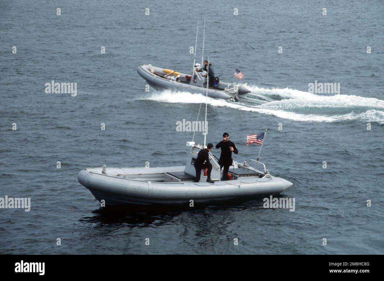 Mitglieder des Helicopter Mine Gegenmaßnahmen Squadron 15 (HM-15) bereiten sich auf die Bergung eines Mark 105 Tragflächenschubschlittens mit starren Schlauchbooten vor. HM-15 nutzt die Amphibienladerampe USS DULUTH (LPD-6) als Basis für die gemeinsame US-kanadische Flottenübung MARCOT '93. Betreff Operation/Serie: MARCOT '93 Land: Straße von Juan De Fuca Stockfoto
