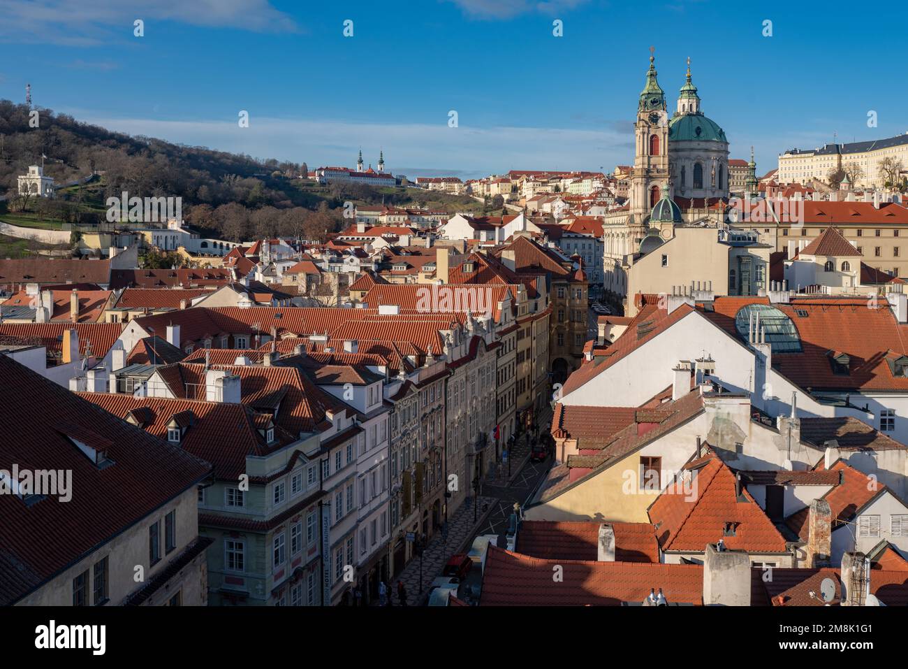 Die kleinere Stadt Prag vom Charles-Brigde-Turm aus gesehen, ein Blick in Richtung Mostecká-Straße, St. Nicholas Kirche an einem sonnigen, klaren Tag. Stockfoto