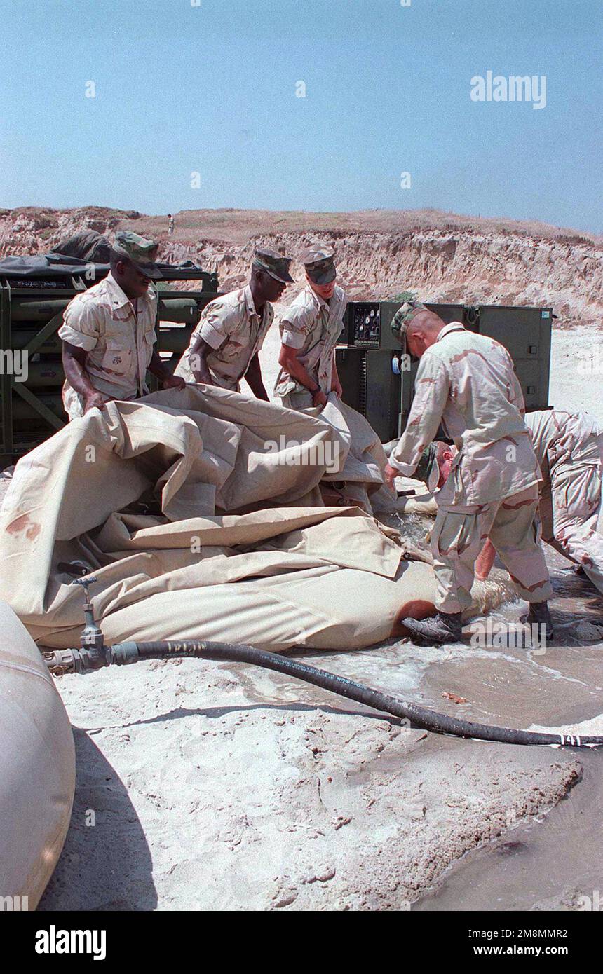 Marines von Utilities, Marine Wing Support Squadron (MWSS) 374, 3. Marine Air Wing, leeren eine 3.000 Gallonen Wasserblase, weil sie Sand aus Red Beach enthielt. Betreff Operation/Serie: KERNEL BLITZ '97 Base: Marine Corps Base Camp Pendleton Bundesstaat: Kalifornien (CA) Land: Vereinigte Staaten von Amerika (USA) Stockfoto