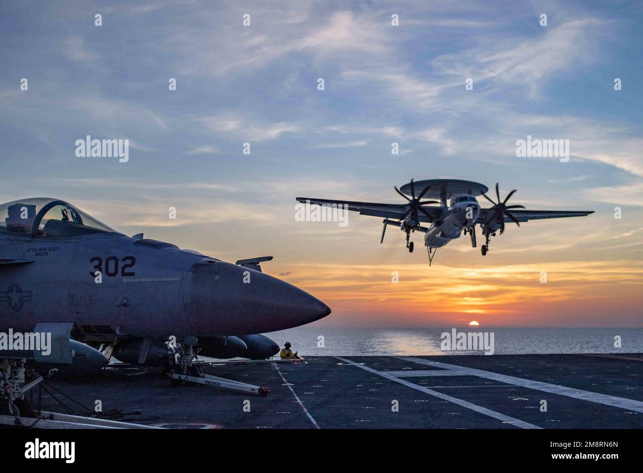 Uss Nimitz, Internationale Gewässer. 13. Januar 2023. USS Nimitz, internationale Gewässer. 13. Januar 2023. EIN US-AMERIKANISCHER Navy E-2C Hawkeye Frühwarnflugzeug der Sun Kings des Flugzeugträger Airborne Frühwarngeschwaders 116, Landeanflüge auf dem Cockpit des Flugzeugträgers der Nimitz-Klasse USS Nimitz bei Sonnenuntergang, die Routineeinsätze durchführen, 13. Januar 2023 im Südchinesischen Meer. Kredit: MC2 David Rowe/U.S Navy Photo/Alamy Live News Stockfoto