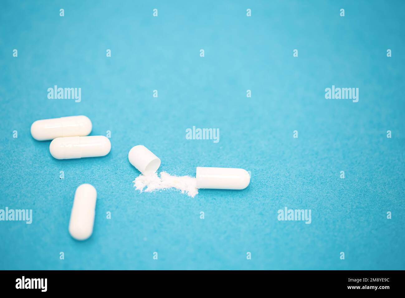 Pillen auf blauem Hintergrund, Nahaufnahme, medizinisches Konzept. Stockfoto