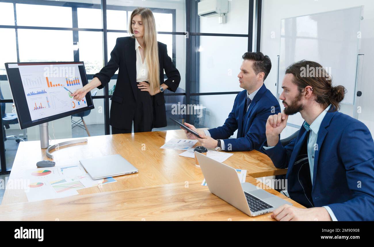 Teambesprechung junger Investor-Geschäftsleute und Geschäftsfrauen zur Analyse von Risiko- und Gewinnchancen bei Investitionen an internationalen Aktienmärkten. Geschäft f Stockfoto