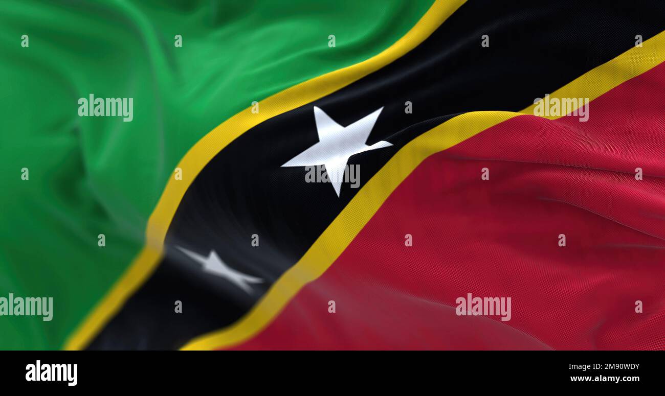Die Nationalflagge von St. Kitts und Nevis winkt. St. Kitts and Nevis Federation ist ein Inselstaat in Mittelamerika. Geriffelter Stoff. Strukturierter Hintergrund Stockfoto