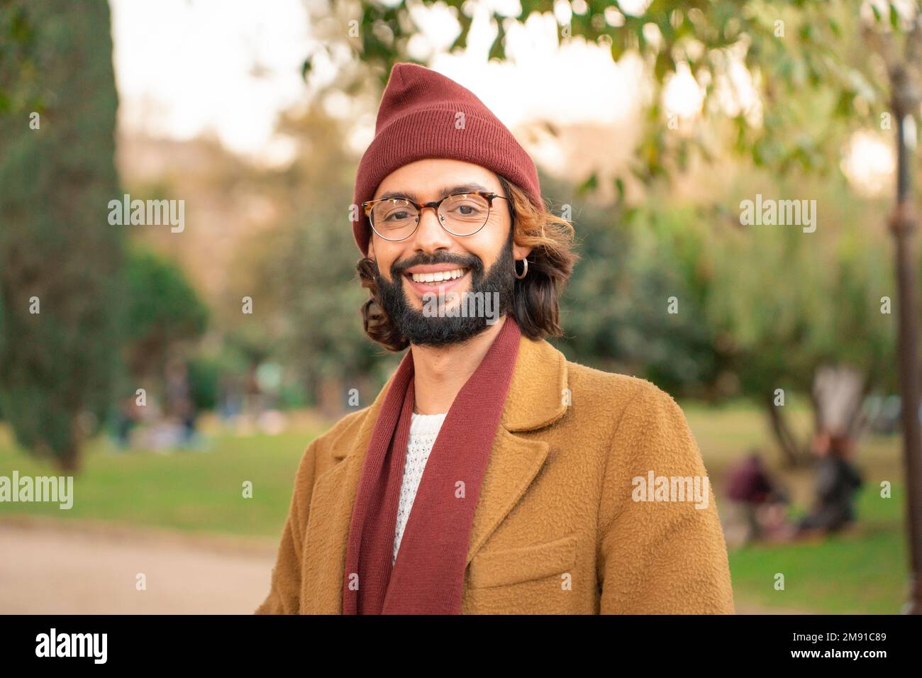 Porträt eines jungen erwachsenen Mannes, der vor die Kamera schaut. Hipster-Mann mit Brille und Bart. Stockfoto
