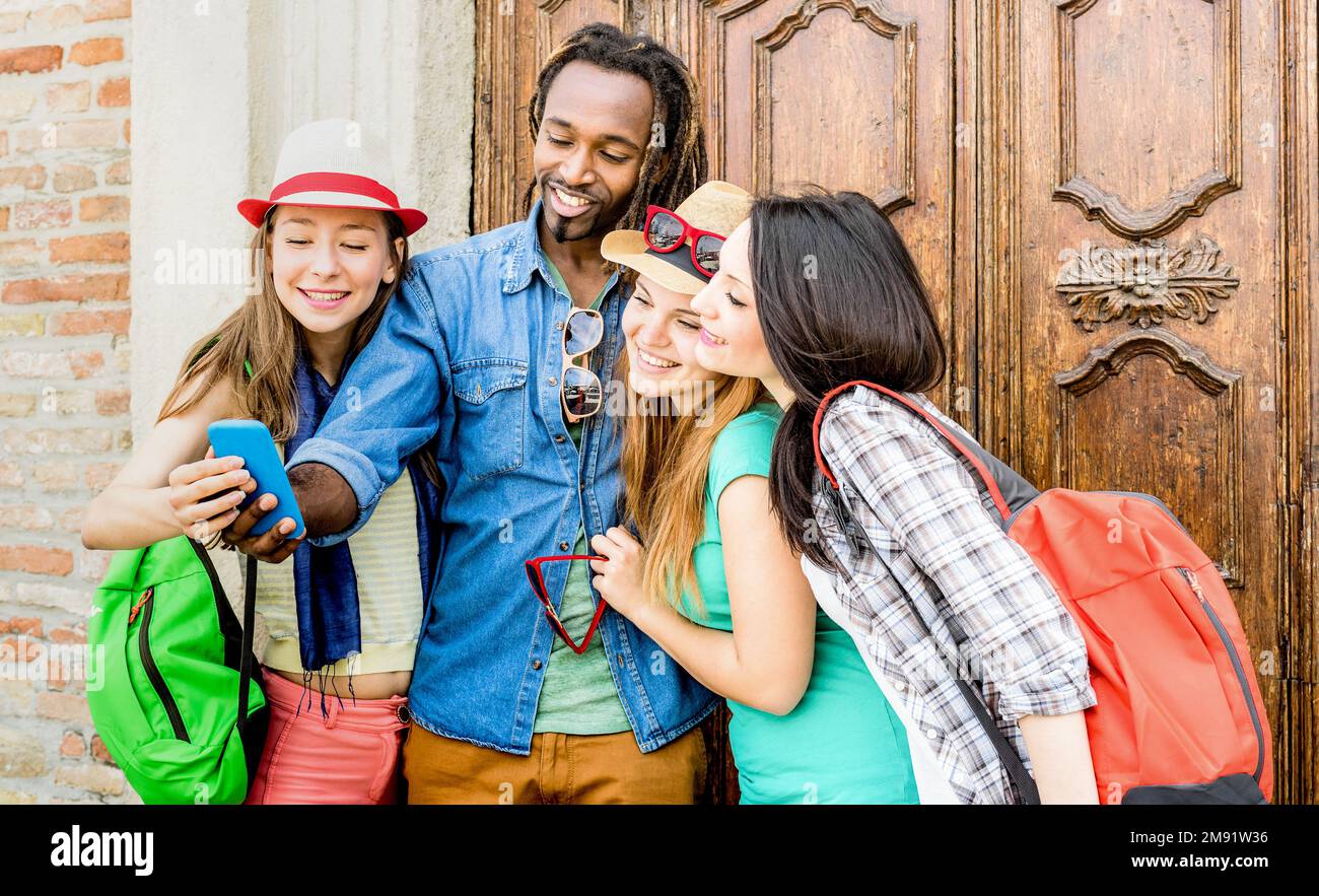 Gruppe glücklicher multiethnischer Freunde, die Selfie mit dem Smartphone machen - Junge Hipster, die in sozialen Netzwerken von Smartphones abhängig sind - T Stockfoto