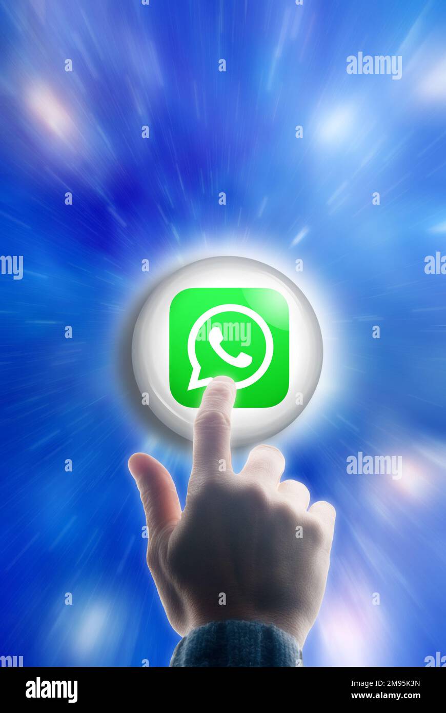 Männliche Hand berührt einen Knopf mit WhatsApp-Logo Stockfoto