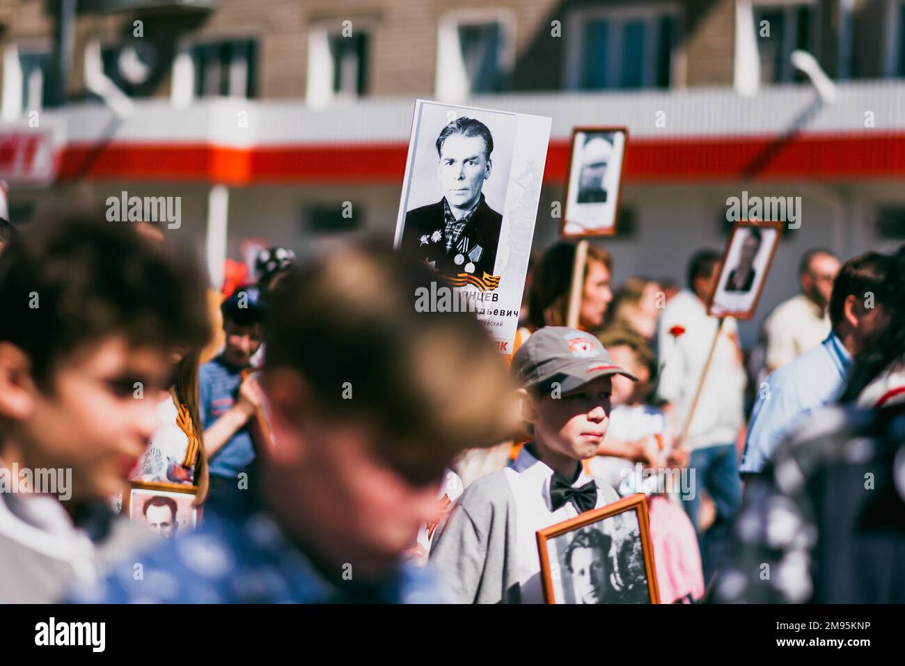 VICHUGA, RUSSLAND - 9. MAI 2015: Unsterbliches Regiment - Menschen mit Porträts ihrer Verwandten, Teilnehmer des Zweiten Weltkriegs, am Siegesfeiertag Stockfoto
