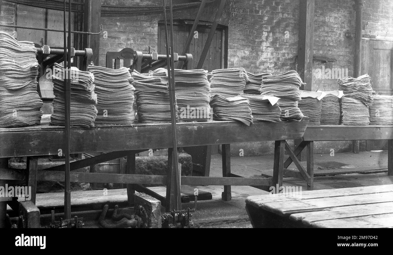 Maschinenbodenwerkstatt in Battersbys Hats – das obere Ende, wo mehr freiliegende Antriebsriemen neben einem Tisch mit Hunderten von Filzkegeln verlaufen, wartet auf die nächste Stufe des Fertigungsprozesses Stockfoto