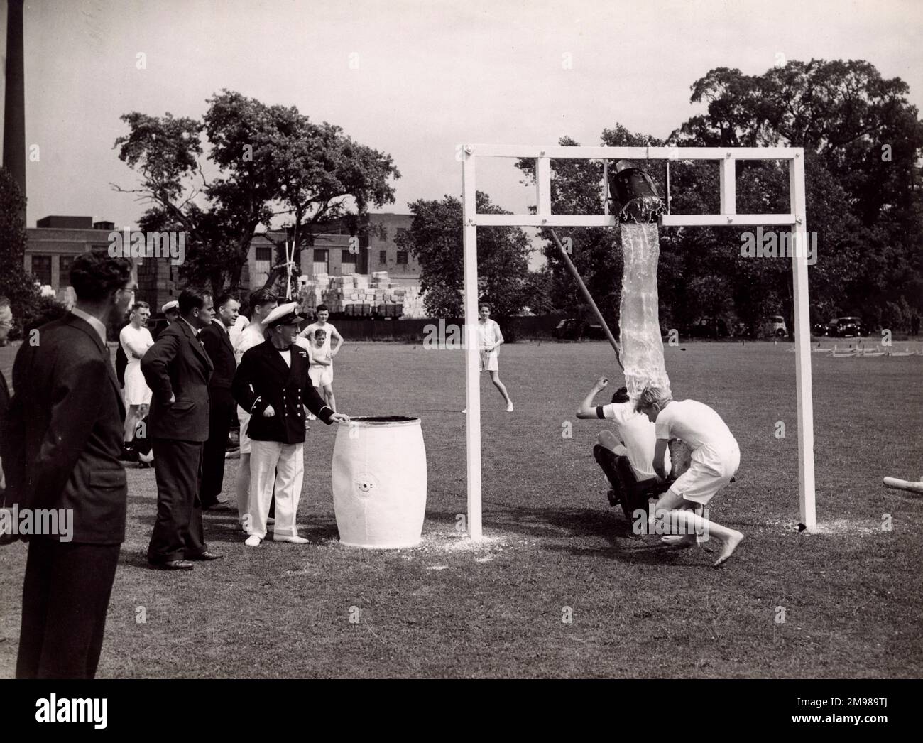 Marinetätigkeiten auf einem Sportplatz mit einem Eimer Wasser. Stockfoto