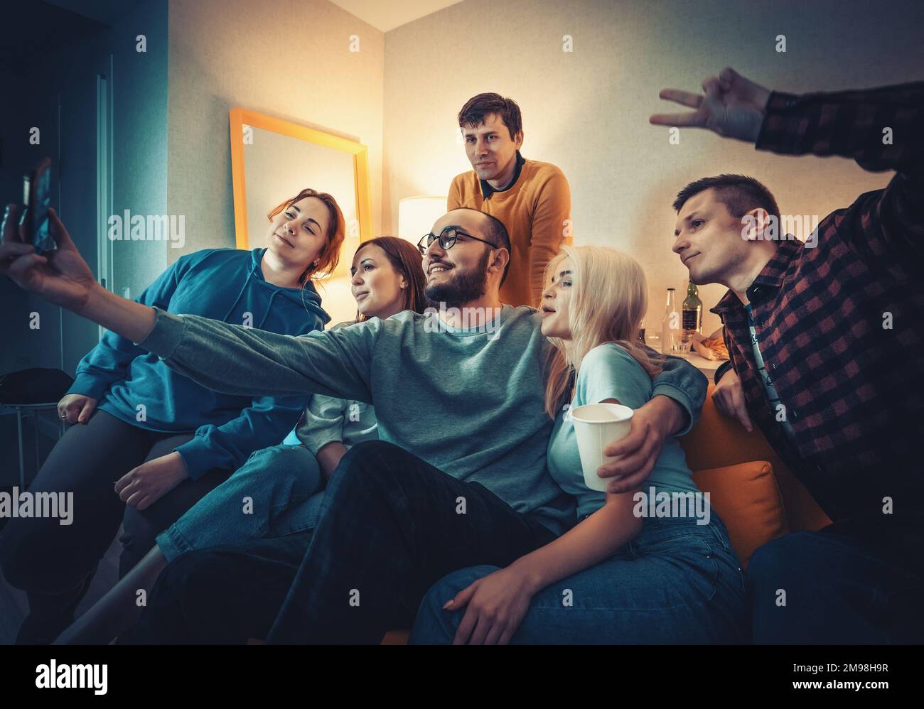 Gruppe junger Menschen, die Selfie auf dem Smartphone auf einer Party und Viel Spaß. machen Freunde genießen ihre Gesellschaft, lächeln. Stockfoto