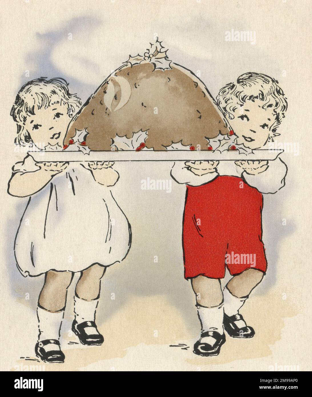 Ein kleiner Junge und ein Mädchen tragen einen sehr großen Weihnachtspudding Stockfoto