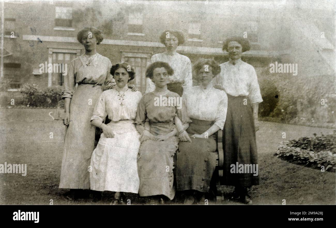 Fünf Frauen posieren für ein Gruppenfoto im schönen Garten eines schönen Hauses. Möglicherweise Schwestern oder Cousins. Stockfoto