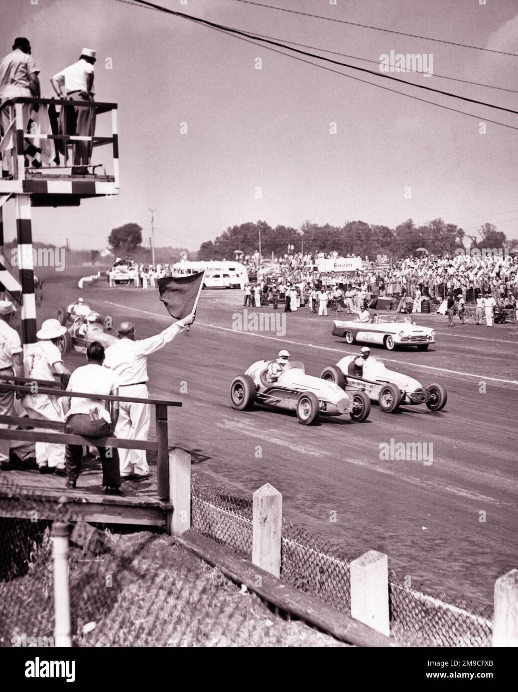 1950S 100-MEILEN-SPORTWAGENRENNEN AUF DEM LANGHORNE SPEEDWAY LANGHORNE PA USA FLAGMAN WACKELT MIT EINER WARNFLAGGE - M676 HAR001 HARS STRATEGIE AUTOS AUFREGUNG PA WARNUNG RISKANTE GEFÄHRLICHE BERUFE GEFÄHRDEN BERUFSSPORT UNSICHERE AUTOS KILOMETERLEISTUNG GEFÄHRDEN BEAMTE RACEWAY KOOPERATION LANGHORNE, ANWESENHEITSLISTE SCHWARZ-WEISS, HAR001 JAHRE ALT Stockfoto