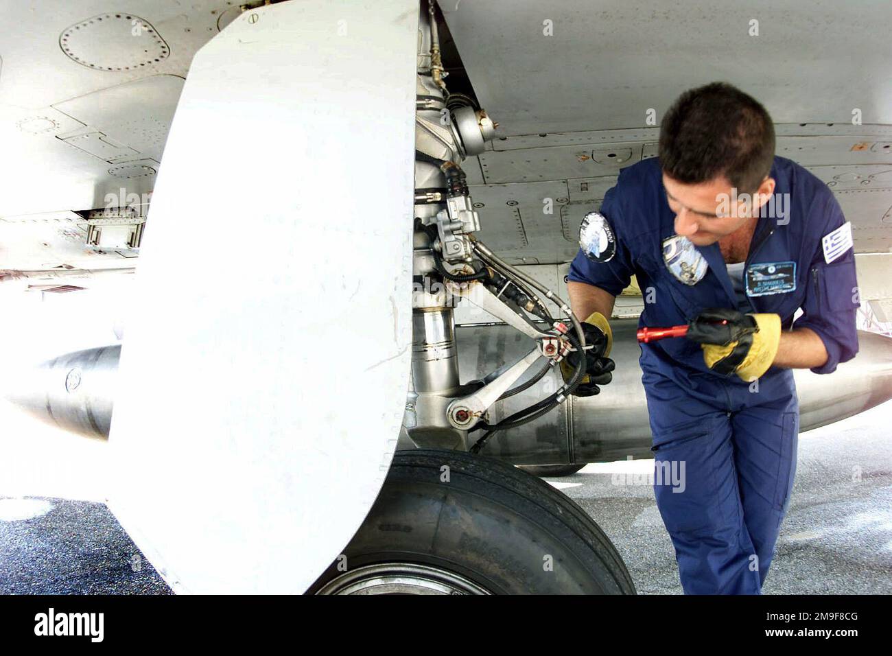 Direkt auf mittlerer Stufe, während MASTER Sergeant Spyros Siakoulas, ein Flugmechaniker der Hellenischen (griechischen) Luftwaffe, 114. Composite Group, 331. Tactical Fighter Wing, Griechenland, nach dem Flug eine Inspektion des Hauptgetriebegerüsts eines Mirage 2000 Fighters durchführt. Die Hellenic-Einheit ist auf der Aviano Air Base, um mit dem 510. Kampfgeschwader zu trainieren. Die Mirages bieten eine wertvolle Schulung, die es den 510.-Kampfpiloten ermöglicht, gegen andere Flugzeugtypen zu trainieren. Stützpunkt: Luftwaffenstützpunkt Aviano Staat: Pordenone Land: Italien (ITA) Stockfoto
