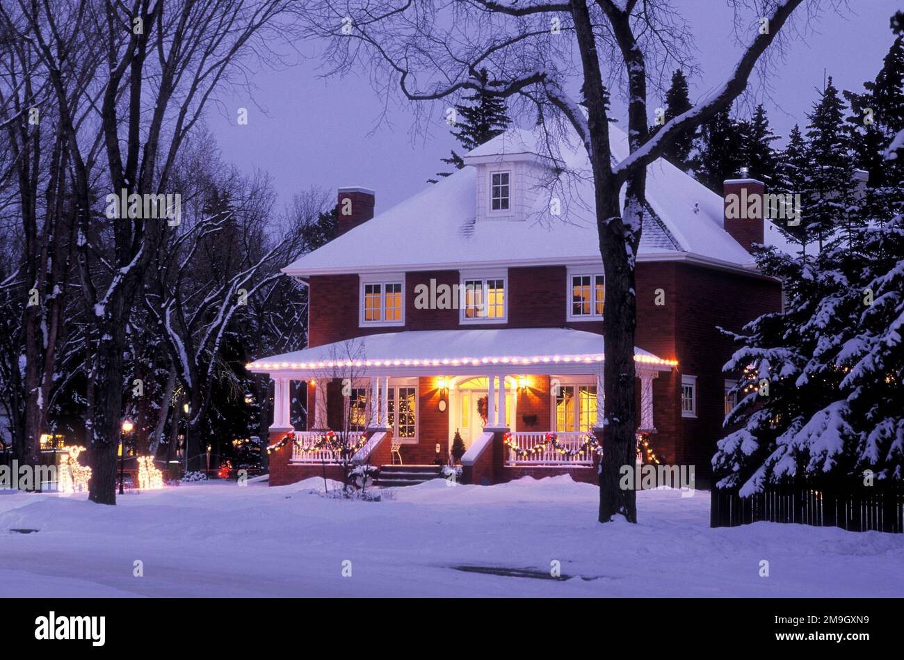 Außenansicht des Hauses am Abend im Winter mit Weihnachtsdekorationen Stockfoto