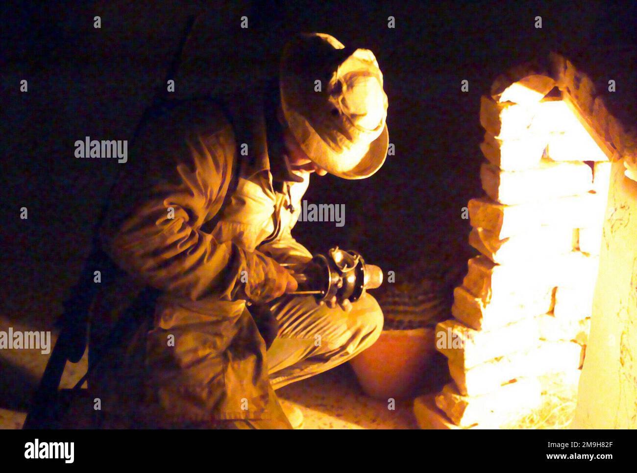 Ein US-Marinebastler mit einem Stück sowjetischer Ausrüstung, der Licht aus dem behelfsmäßigen Altar verwendet, der im Terminal des Internationalen Flughafens Khandahar, Khandahar, Afghanistan, während DER OPERATION DAUERHAFTE FREIHEIT errichtet wurde. (Unterdurchschnittliches Bild). Betreff Operation/Serie: DAUERHAFTE FREIHEITSBASIS: Internationaler Flughafen Khandahar Land: Afghanistan (AFG) Stockfoto