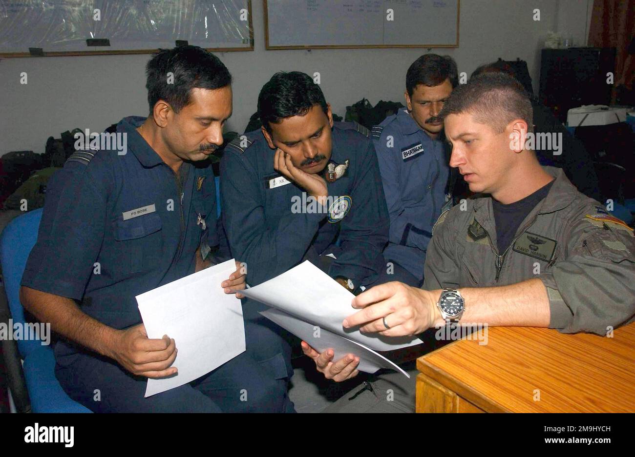 Kapitän der US Air Force (USAF) (CPT) David Hanson (rechts), ein Pilot, der dem 1. Sondereinsatzkommando (SOS), der 353. Special Operations Group (SOG), zugeteilt ist, erörtert Missionsverfahren mit dem Wing Commander der Indian Air Force (IAF), Partha Sarathi Bose (links); Die IAF-Staffelführer NAND Kumar Nair (Zentrum) und IAF Sangeet Bhatnagan, in Vorbereitung auf eine Ausbildungsmission in der Luftwaffenstation Agra, Indien. Mitglieder der 353. SOG werden hier für drei Wochen gemeinsamer Austauschschulung mit den indischen Streitkräften eingesetzt. Basis: Luftwaffenstützpunkt Agra Land: Indien (IND) Stockfoto