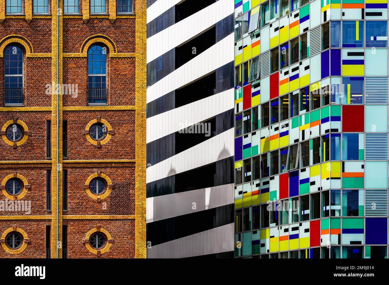 Architektur im Media Harbor Düsseldorf. Blick auf die Fassaden zweier Gebäude. Auf der rechten Seite befindet sich die farbenfrohe Fassade des 16-stöckigen HOTELS. Stockfoto