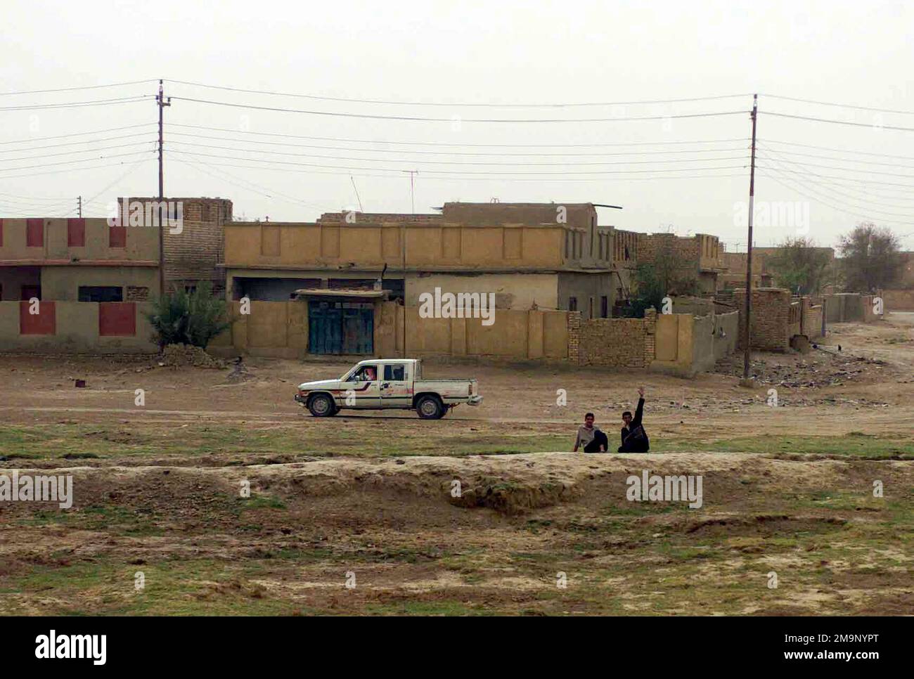 Zwei irakische Kinder spielen während der Operation "IRAKISCHE FREIHEIT" auf einem Drecksberg entlang der Straßenausgänge in der Nähe der Stadt Al Rifa, Irak. Operation/Serie: IRAKISCHE FREIHEITSBASIS: Al-Rifa-Land: Irak (IRQ) Stockfoto