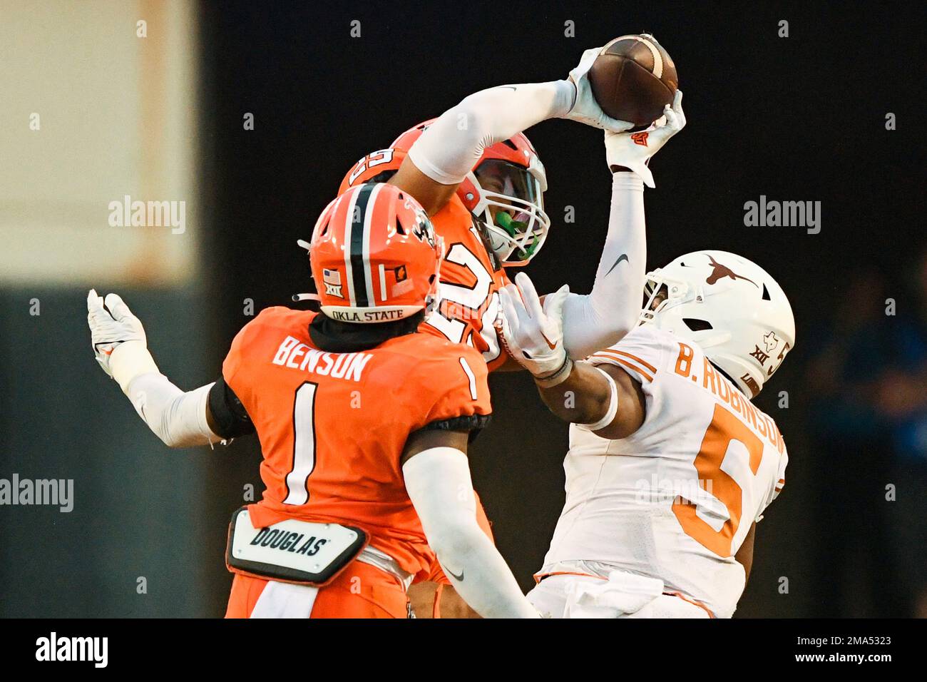 Oklahoma State linebacker Xavier Benson (1) watches as safety Jason
