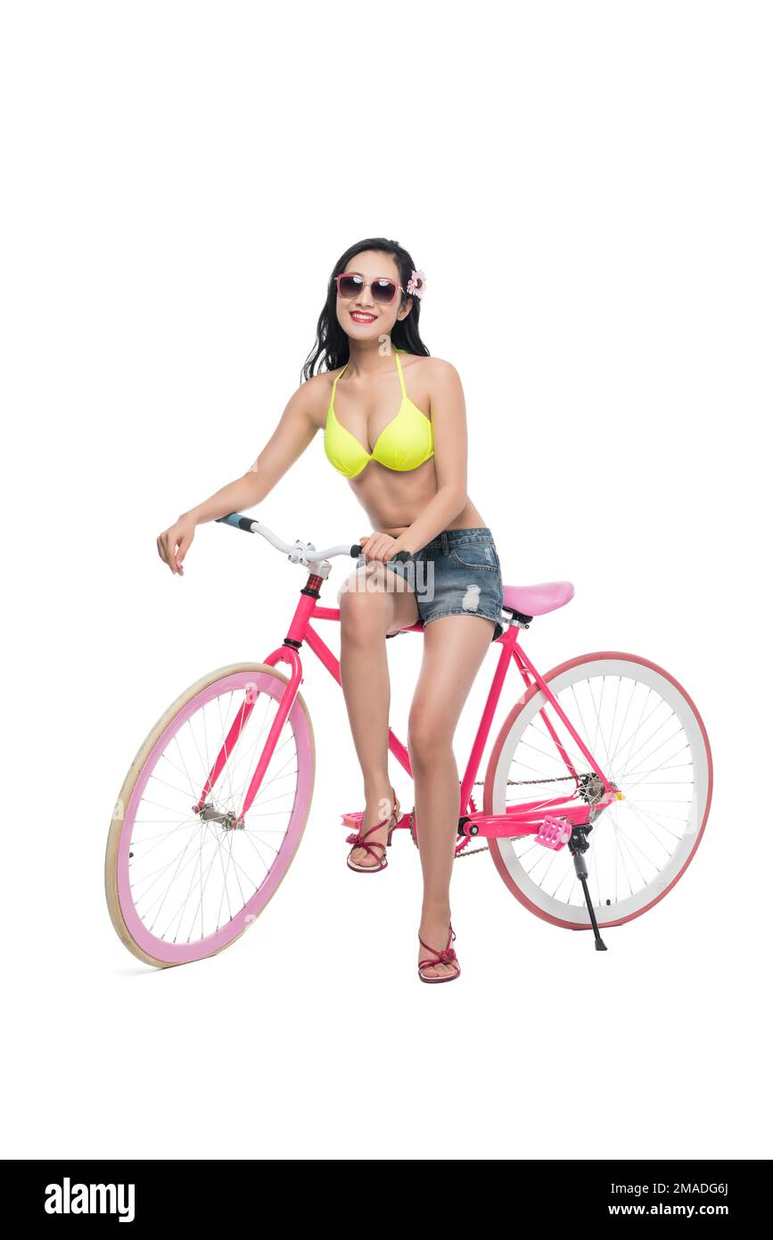 Die junge Frau mit Badeanzug und Fahrrädern Stockfoto