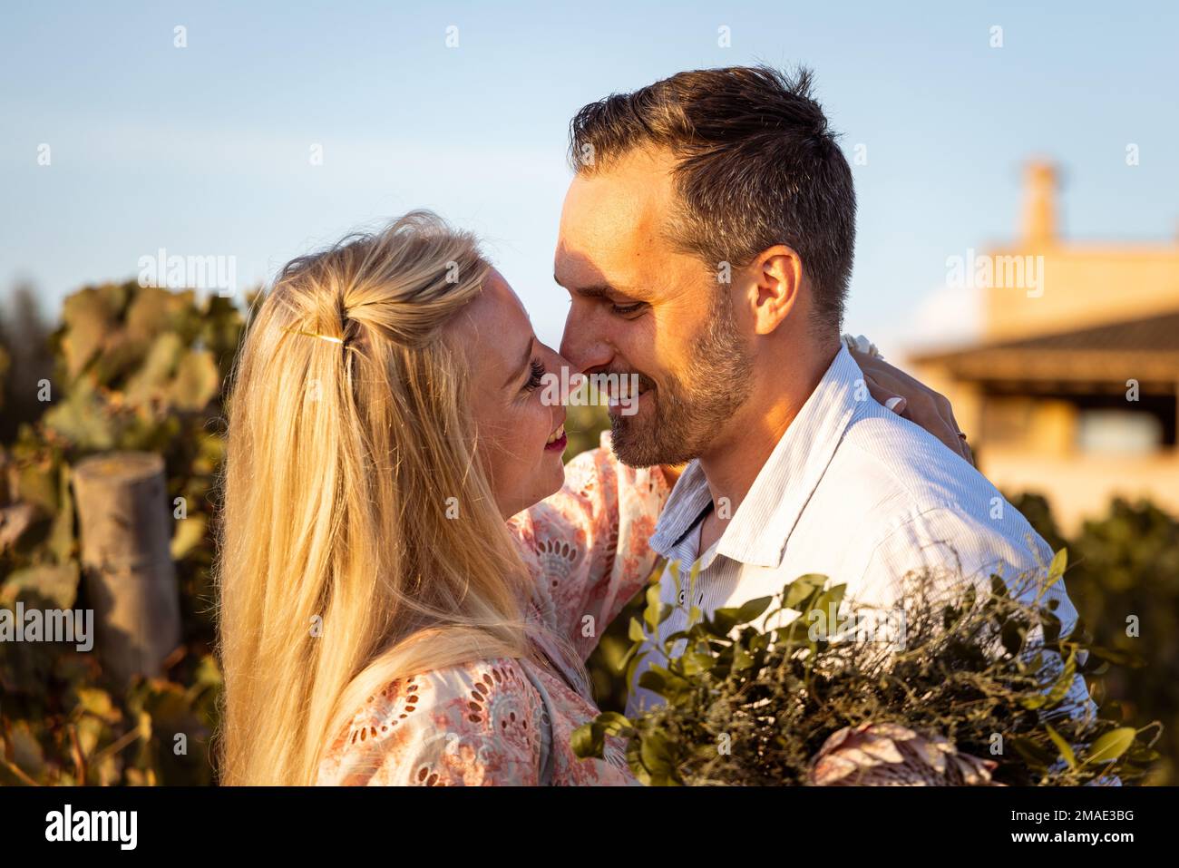 Lächelndes Paar in einem mediterranen Ort, das sich gleich küssen wird Stockfoto