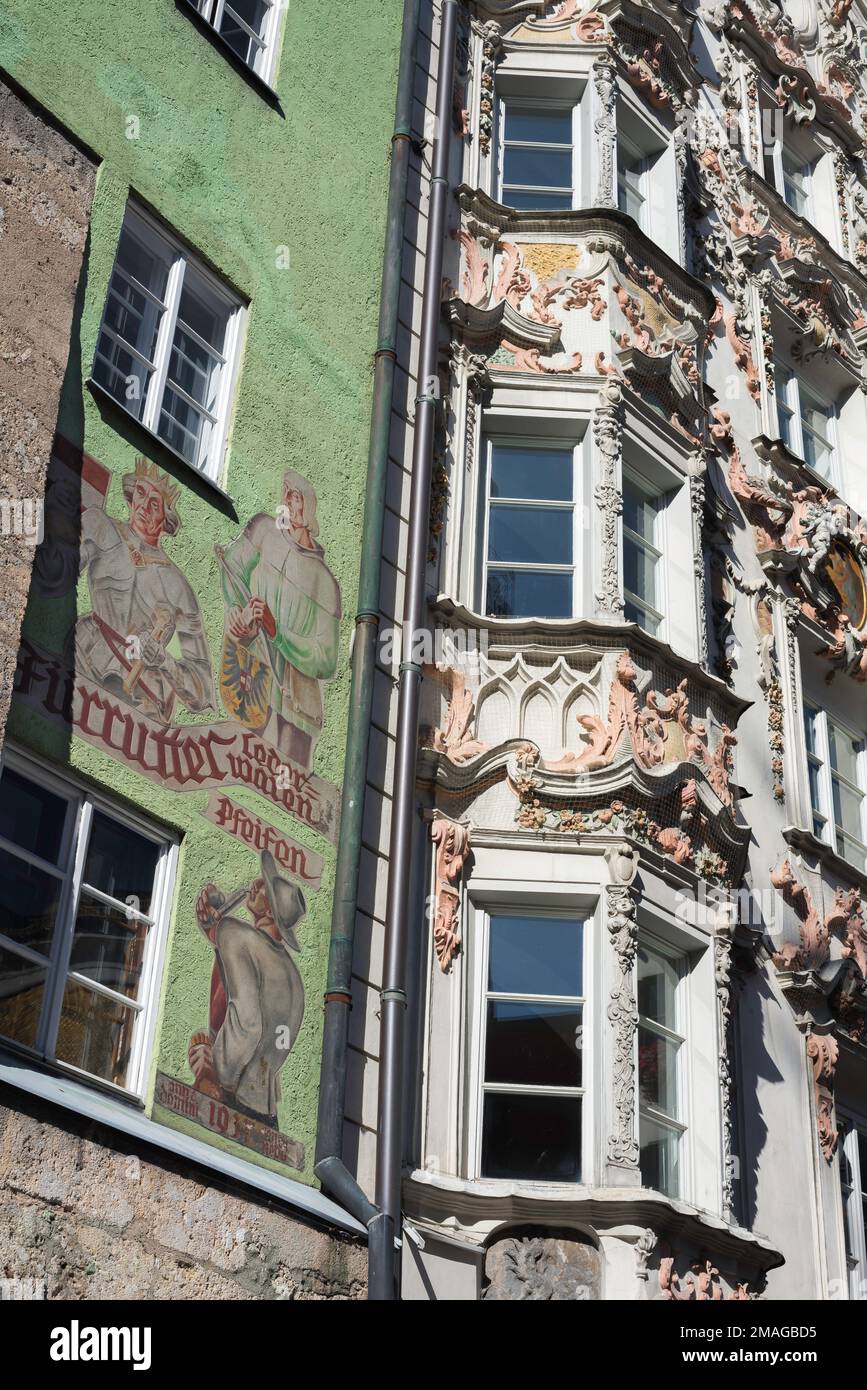 Innsbrucker Barock, verzierte Dekoration am Holbling Haus (R) und ein farbenfrohes Fresko am Handl Tyrol Cafe (L), Innsbrucker Altstadt, Österreich Stockfoto