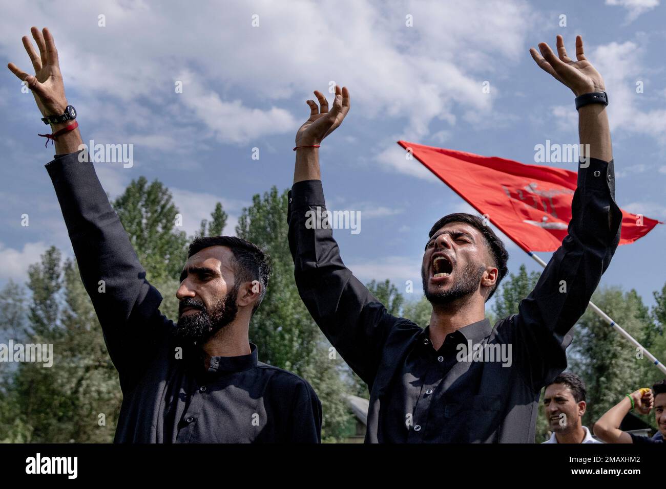 Kashmiri Shiite Muslims shout religious slogans as they participate in ...