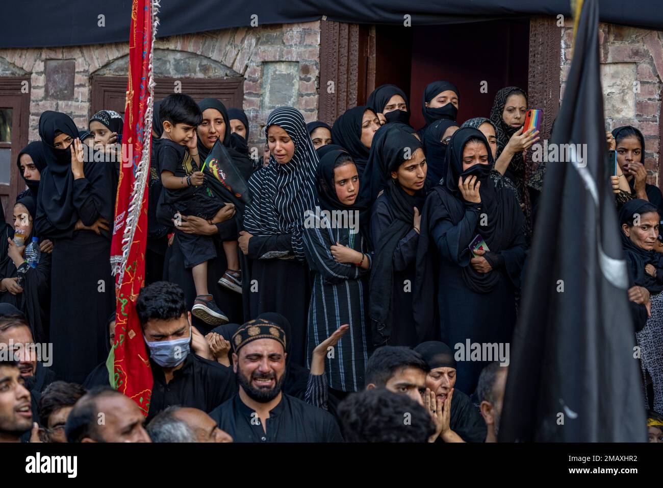 Kashmiri Shiite Muslim women mourn as they watch Muharram procession in ...