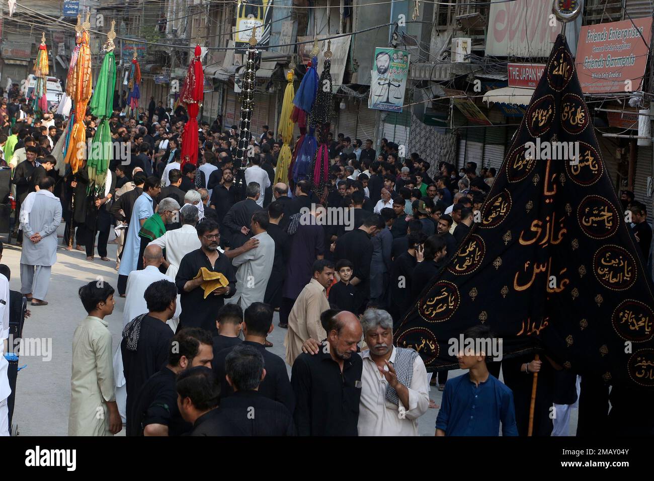Shiite Muslims attend a Muharram procession, in Peshawar, Pakistan ...
