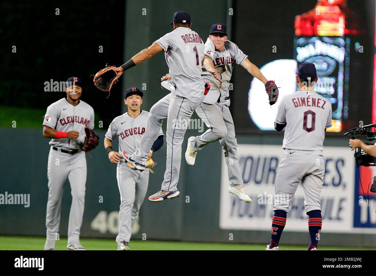 FILE Cleveland Guardians' Amed Rosario (1) and Myles Straw jump