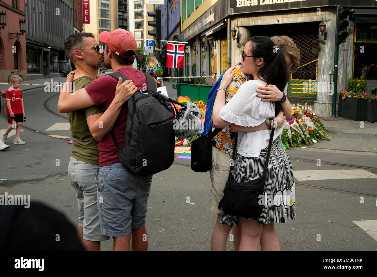 People comfort each other at the scene of a shooting in central Oslo