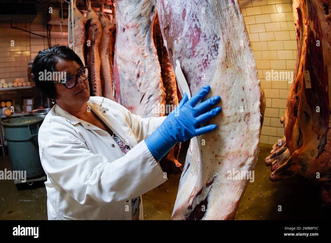 In this photo made on Thursday, June 16, 2022, part owner Stacey Richard checks over sides of