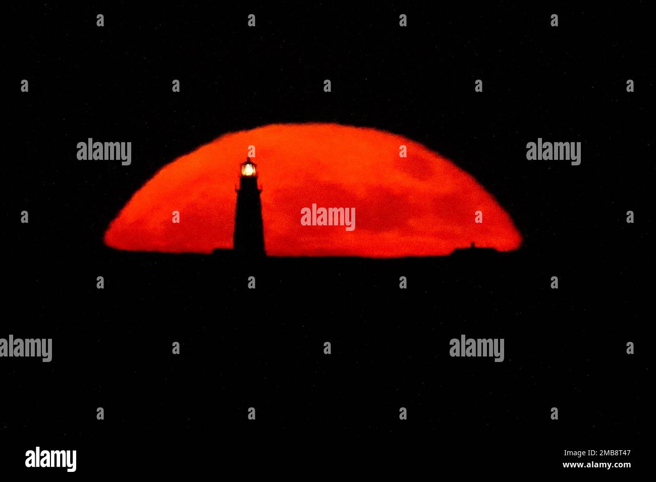 a-full-moon-rises-behind-the-boston-light-late-tuesday-june-14-2022