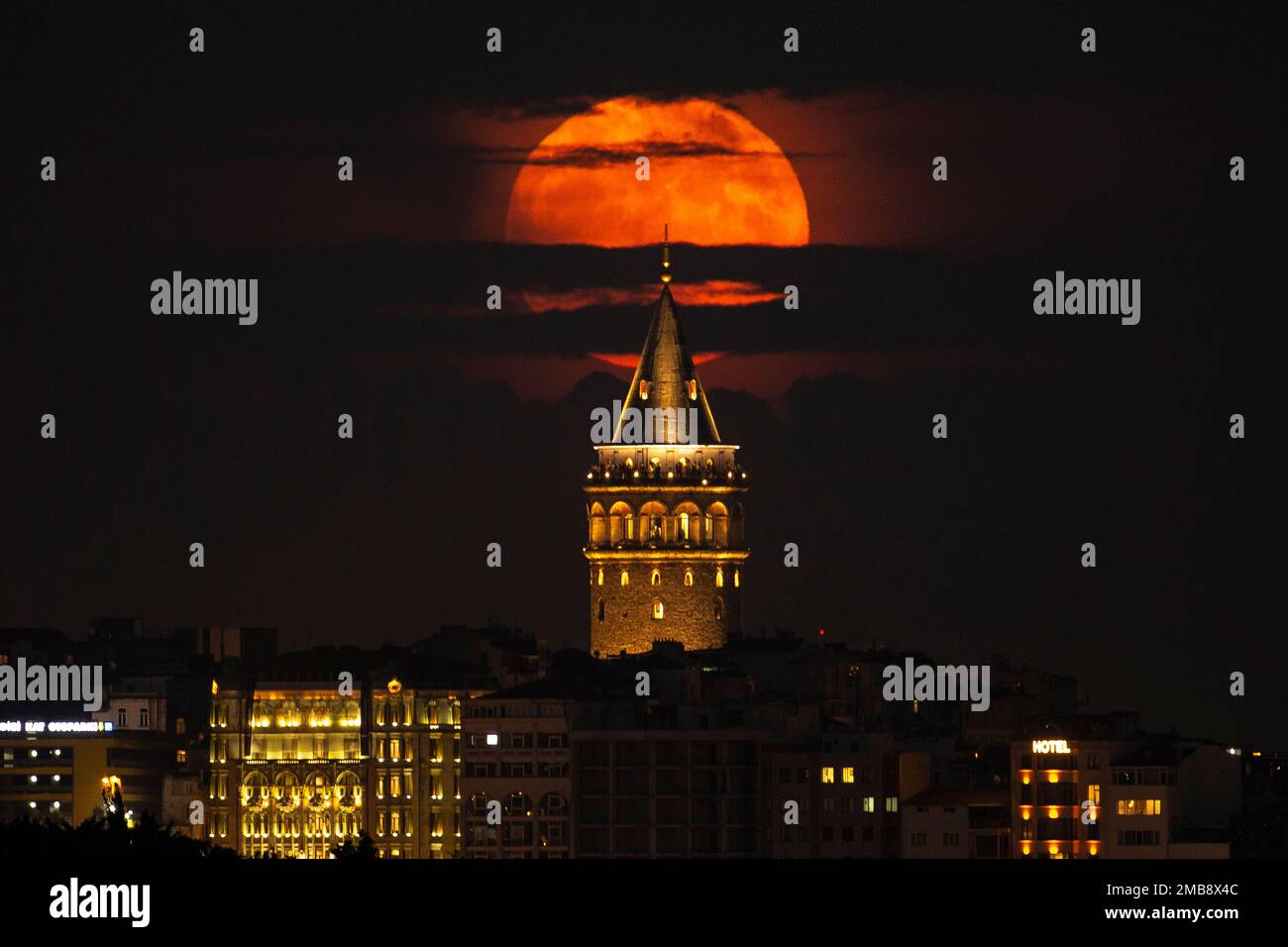 A supermoon rises behind the Galata Tower in Istanbul, Turkey, Tuesday ...