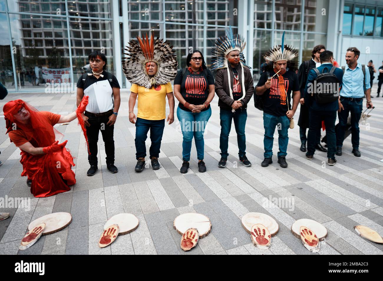 Indigenous representatives from Brazil protest outside Paris courthouse, in Paris, Thursday, June 9, 2022. Environmental groups and representatives of Brazil's Indigenous community are protesting Thursday outside the main Paris courthouse, urging a quick trial for a French supermarket chain accused of selling beef linked to deforestation and land grabs in the Amazon rainforest. (AP Photo/Thibault Camus) Stockfoto