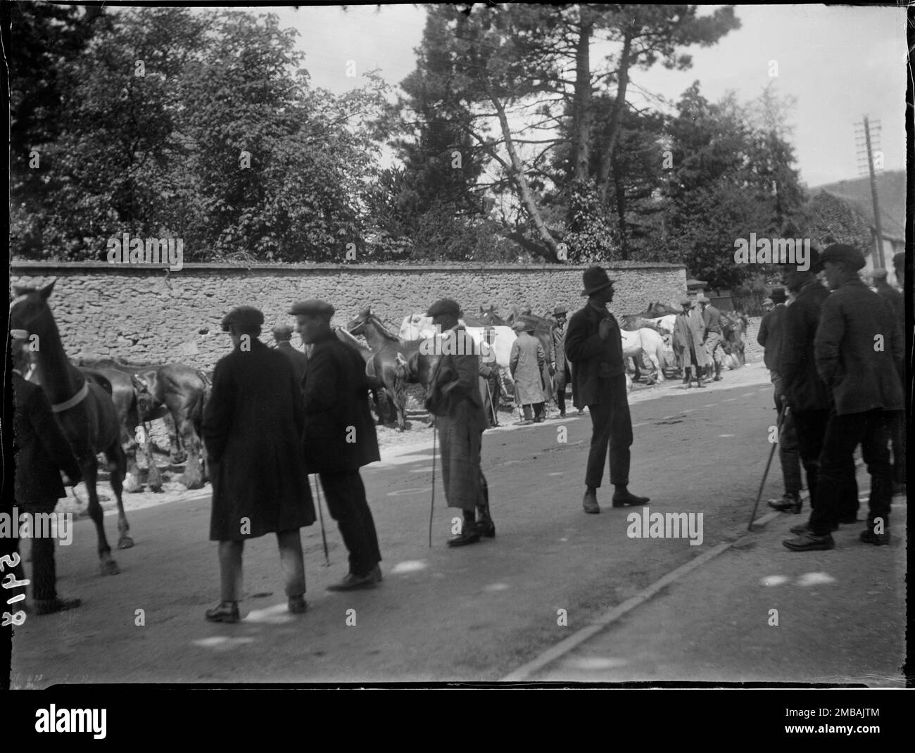 Fosse Way, Stow-on-the-Wold, Cotswold, Gloucestershire, 1928. Eine Gruppe von Männern, die Pferde in einem Zigeunerpferdverkauf auf der Hauptstraße der Stow Horse Fair anschauen. Stockfoto