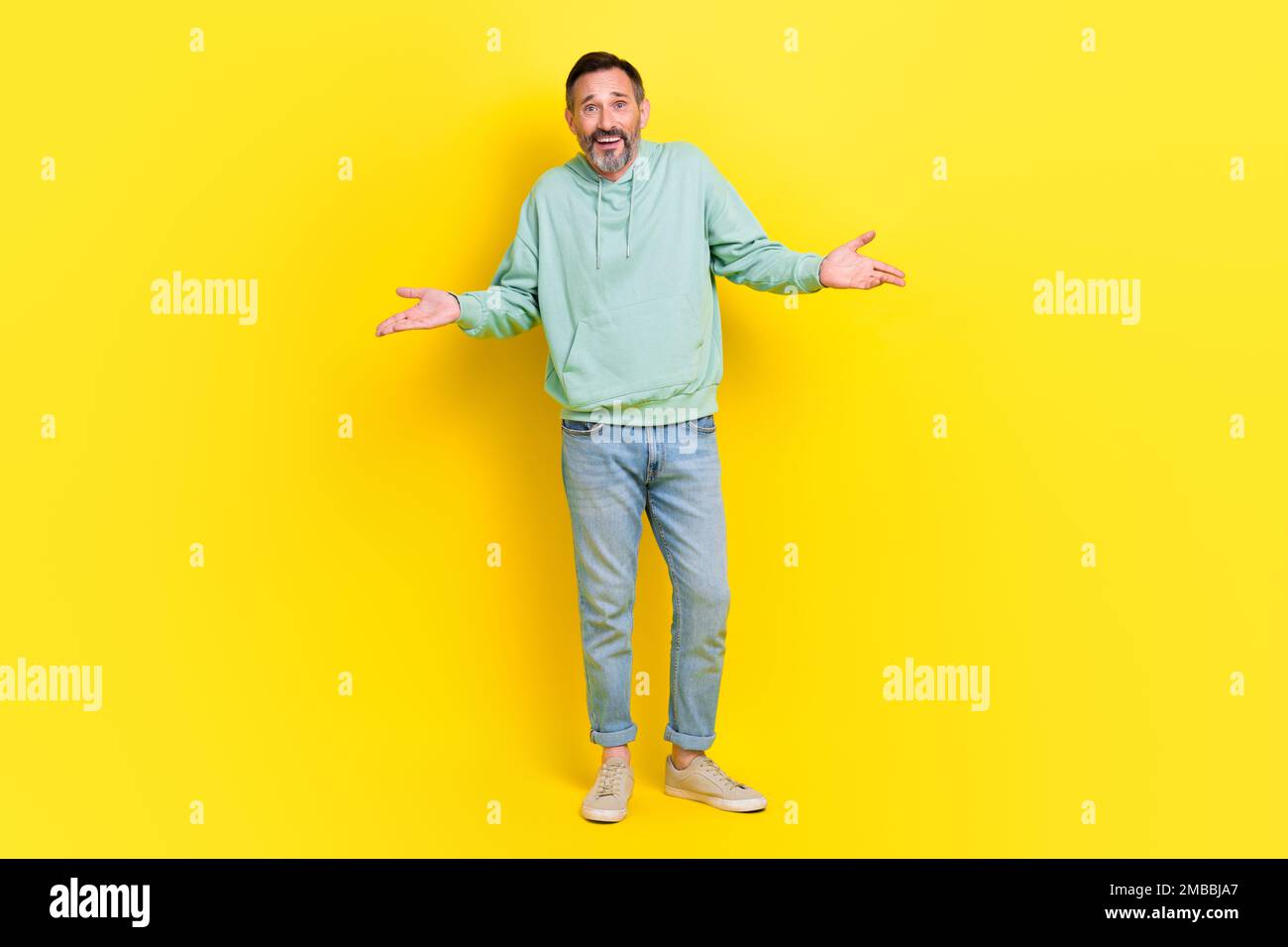 Ein Foto in voller Länge von einem flippigen Mann trägt trendige Kleidung hebt die Hände und zeigt keine Antwort, tut mir leid, steht leer, isoliert auf gelbem Hintergrund Stockfoto