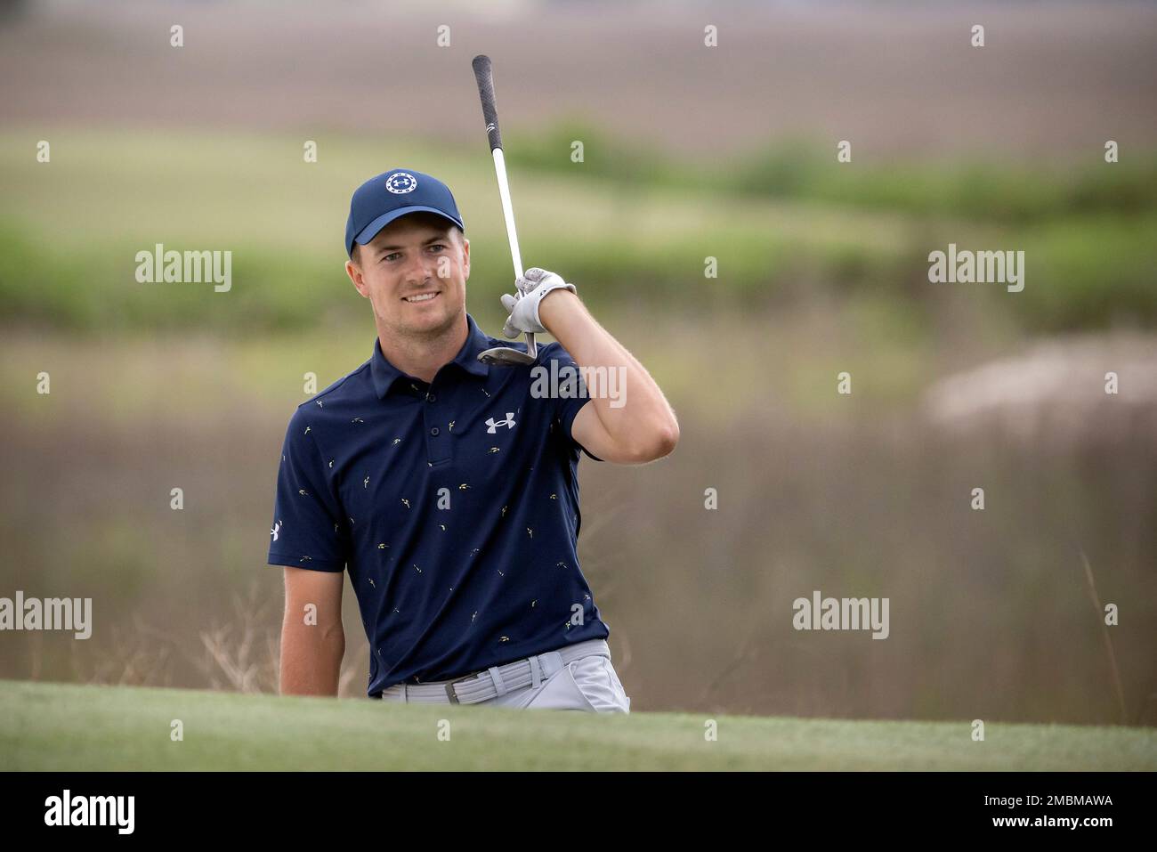 Jordan Spieth celebrates from the front bunker after chipping in at the