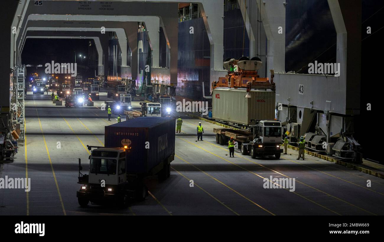 Five ship to shore cranes and gangs of longshoremen work the 1,199-foot ...